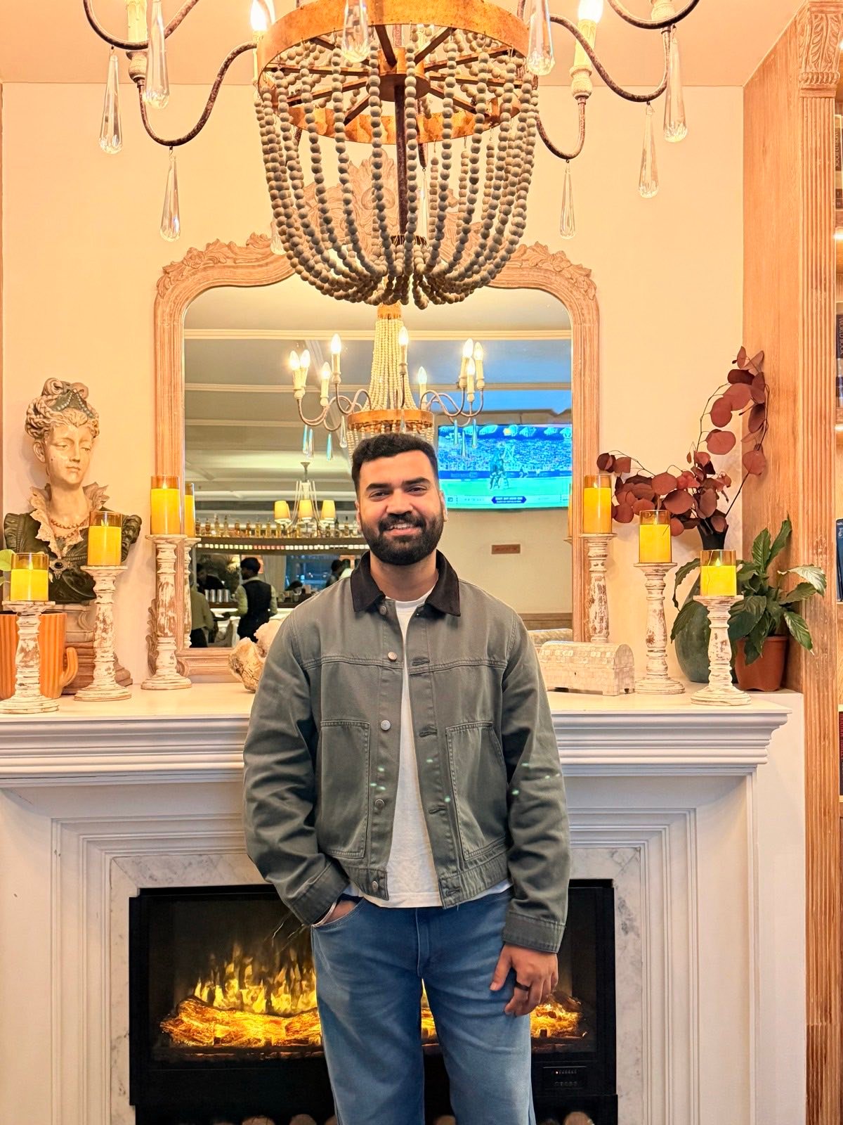 Rishav in front of a fireplace