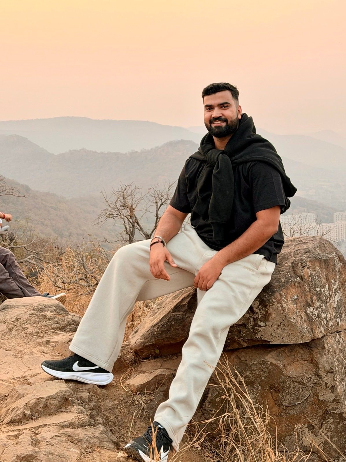 Rishav on a hilltop at sunset